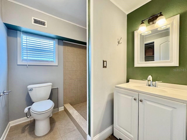 bathroom featuring tile patterned flooring, vanity, toilet, and tiled shower