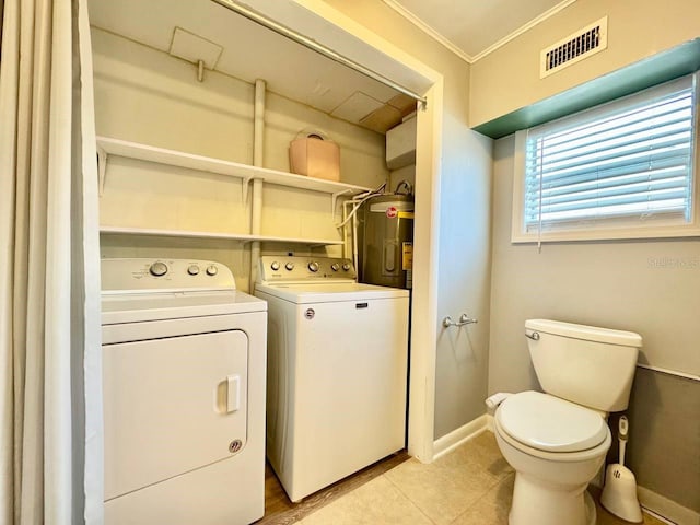 washroom with crown molding, separate washer and dryer, light tile patterned flooring, and water heater