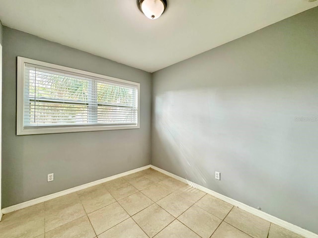 spare room featuring a healthy amount of sunlight and light tile patterned floors