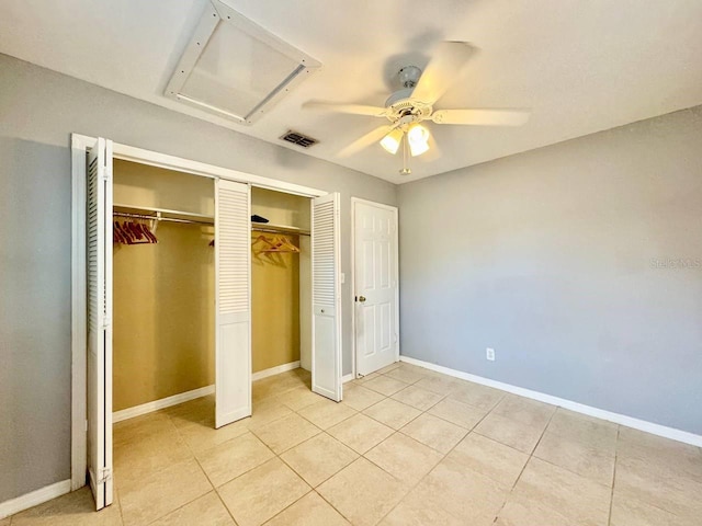 unfurnished bedroom featuring light tile patterned floors, a closet, and ceiling fan