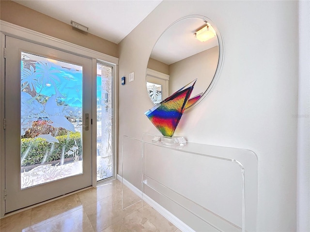 foyer featuring light tile patterned flooring