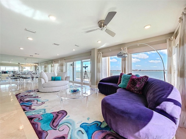 living area featuring a water view, visible vents, a ceiling fan, and recessed lighting