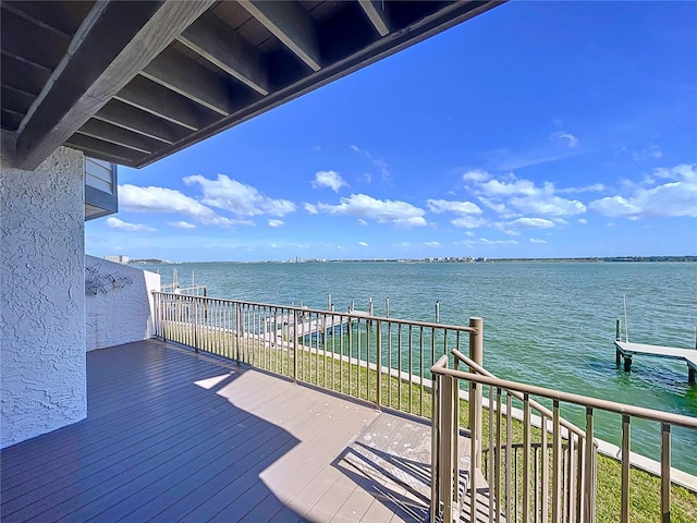 wooden terrace featuring a water view