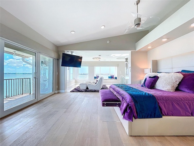 bedroom featuring vaulted ceiling, multiple windows, light wood-style flooring, and access to exterior