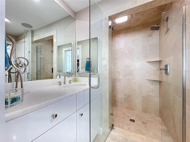 full bathroom featuring a stall shower and vanity