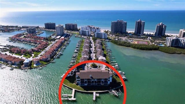 birds eye view of property featuring a water view and a view of city