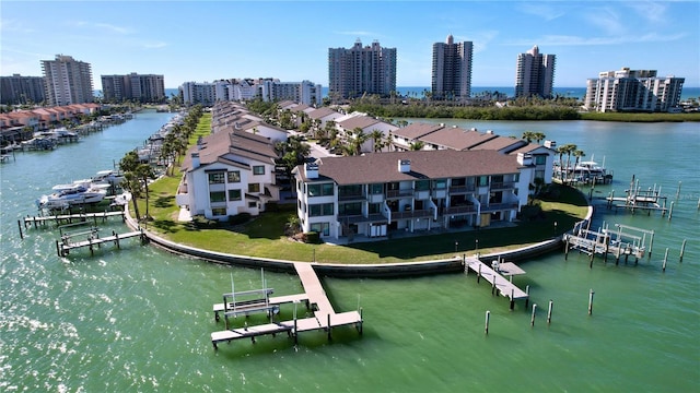 birds eye view of property featuring a water view and a city view