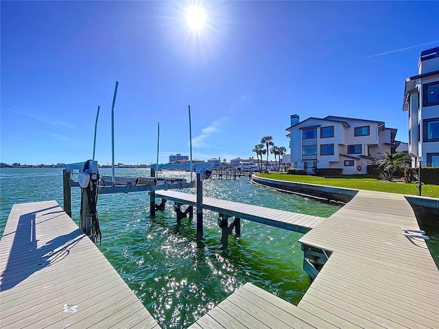 dock area with a water view and boat lift