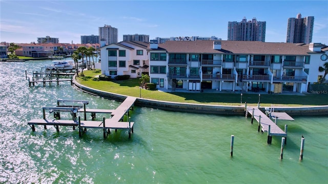 view of dock with a water view, boat lift, and a city view