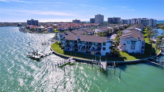 drone / aerial view featuring a water view and a view of city