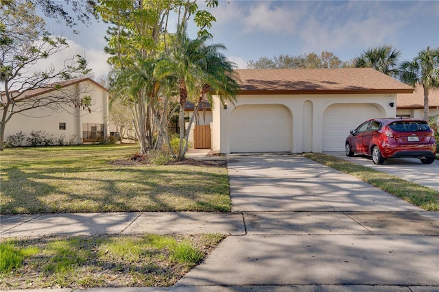 view of front of property with a garage and a front lawn