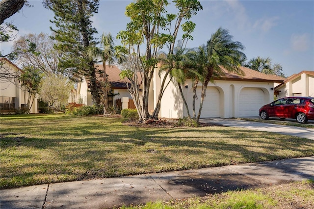 view of front facade featuring a garage and a front lawn