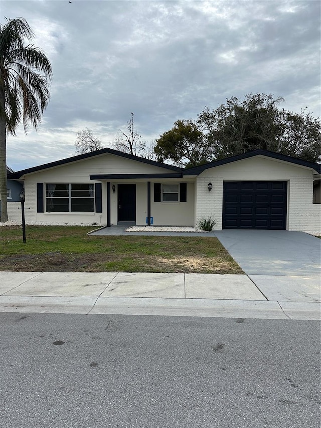 ranch-style home with a garage and a front yard