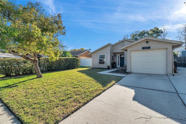 ranch-style house with a garage and a front yard