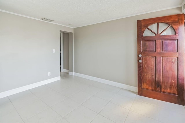 tiled foyer featuring crown molding and a textured ceiling