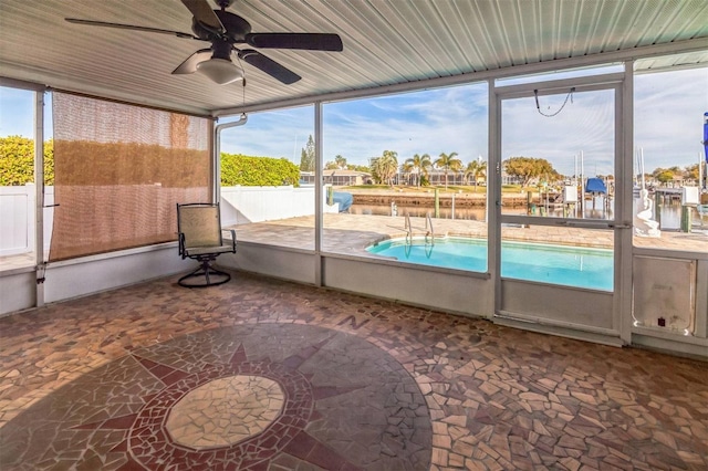 unfurnished sunroom with plenty of natural light and ceiling fan