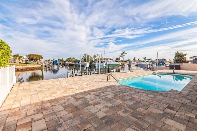 view of swimming pool with a dock and a water view