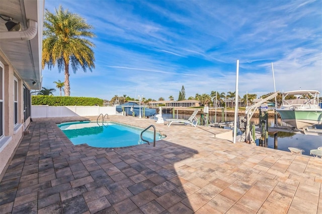 view of pool featuring a water view and a boat dock