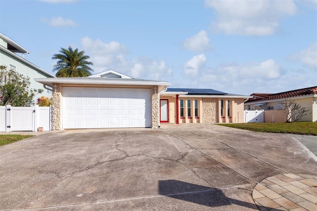 view of front of home featuring a garage and solar panels