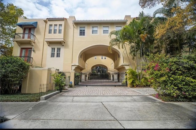 view of front of house featuring a gate and stucco siding