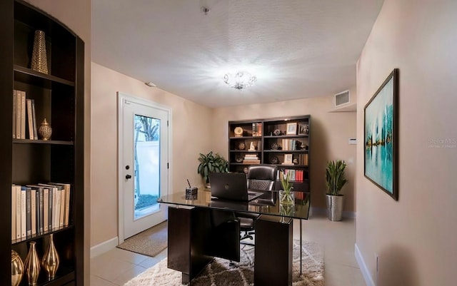 tiled office with baseboards and visible vents