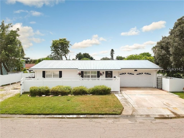 ranch-style home featuring a garage and a front lawn