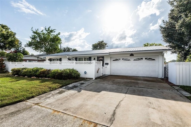 ranch-style house with a garage and a front yard