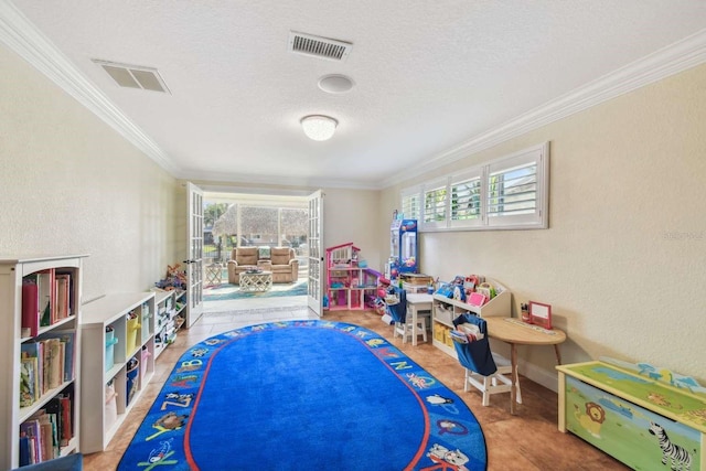 playroom featuring crown molding and a textured ceiling