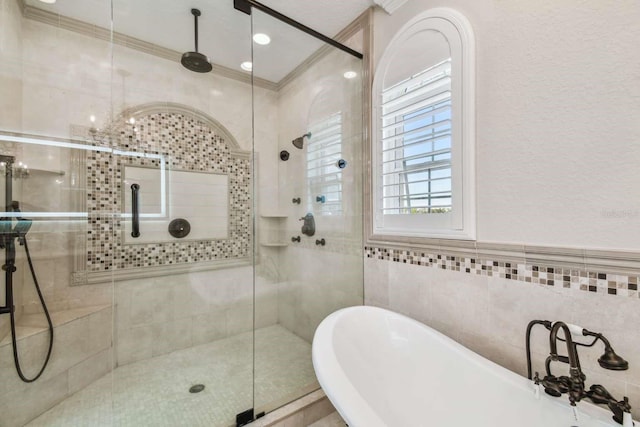 bathroom with ornamental molding, independent shower and bath, and tile walls