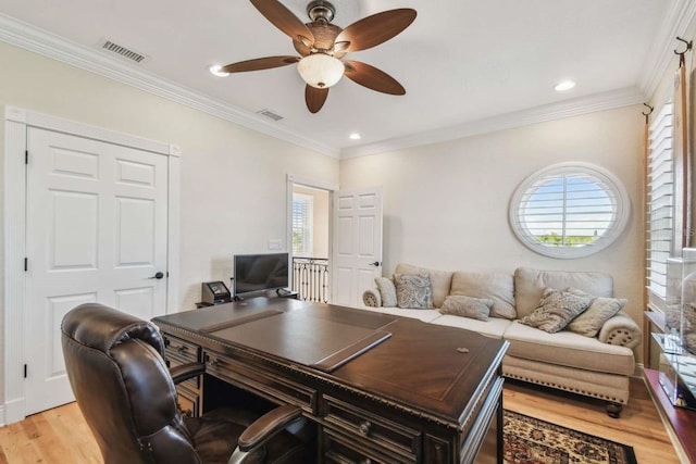 office featuring ceiling fan, ornamental molding, a wealth of natural light, and light hardwood / wood-style floors