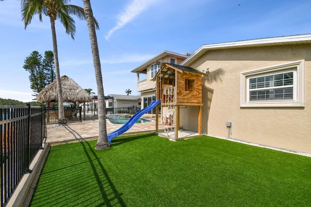 view of play area featuring a yard, a gazebo, and a patio area