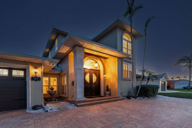 exterior entry at twilight with a garage