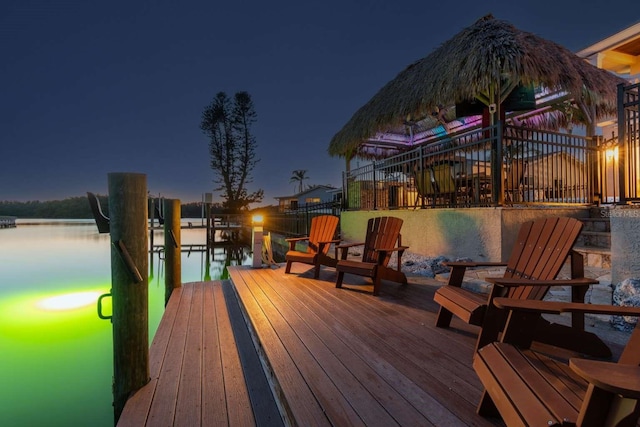 wooden deck with a water view and a dock