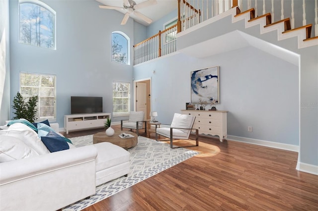 living room with hardwood / wood-style flooring and ceiling fan