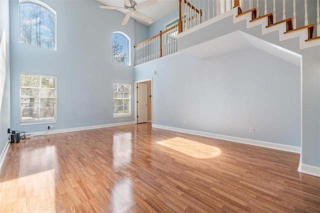 unfurnished living room with hardwood / wood-style flooring and ceiling fan