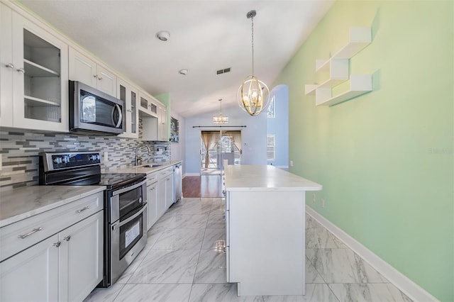 kitchen featuring sink, a center island, pendant lighting, stainless steel appliances, and white cabinets