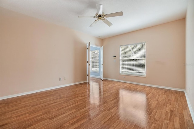 empty room featuring ceiling fan and light hardwood / wood-style flooring