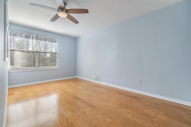 empty room with light hardwood / wood-style floors and ceiling fan