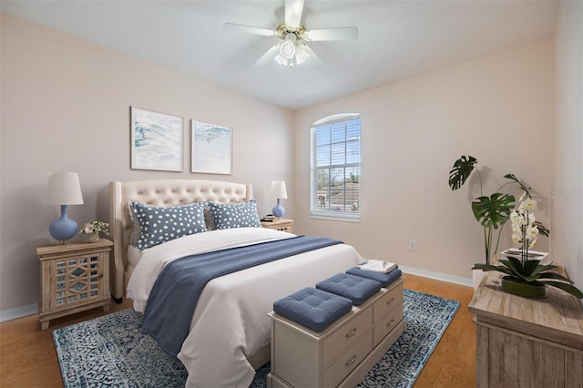 bedroom with ceiling fan and light hardwood / wood-style flooring