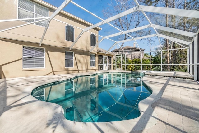 view of swimming pool featuring a lanai and a patio area