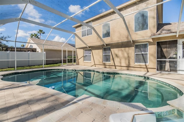 view of pool with a patio and glass enclosure