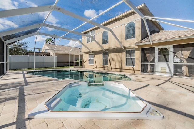 view of pool with an in ground hot tub, a lanai, and a patio area