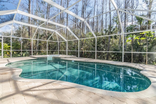 view of swimming pool featuring a lanai and a patio area