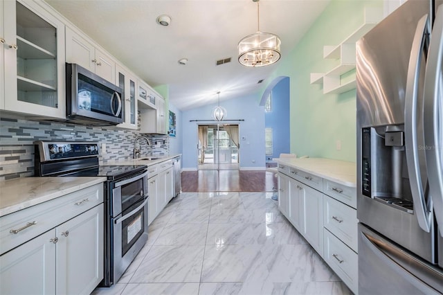 212 Arbor Woods Cir, Oldsmar, FL 34677 - kitchen featuring arched walkways, vaulted ceiling, appliances with stainless steel finishes, marble finish floor, and a sink