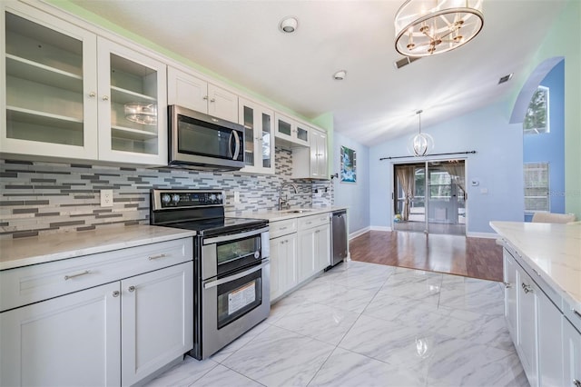 212 Arbor Woods Cir, Oldsmar, FL 34677 - kitchen featuring vaulted ceiling, an inviting chandelier, stainless steel appliances, marble finish floor, and a sink