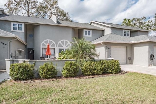 view of front of house with a garage and a front yard