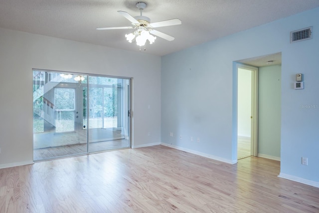 spare room featuring a textured ceiling, light hardwood / wood-style floors, and ceiling fan