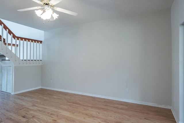 spare room with ceiling fan and light wood-type flooring