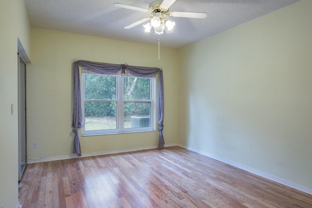 unfurnished room with ceiling fan, light hardwood / wood-style flooring, and a textured ceiling