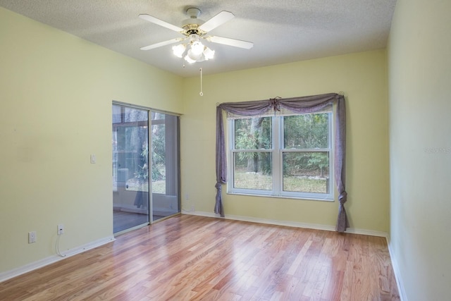 spare room with ceiling fan, light hardwood / wood-style floors, and a textured ceiling